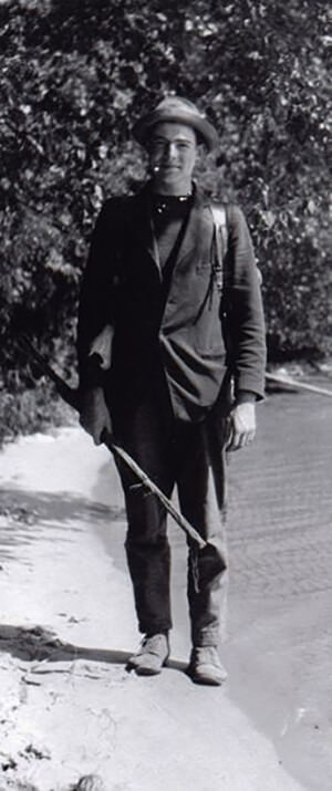Young Hemingway on Beach with Backpack